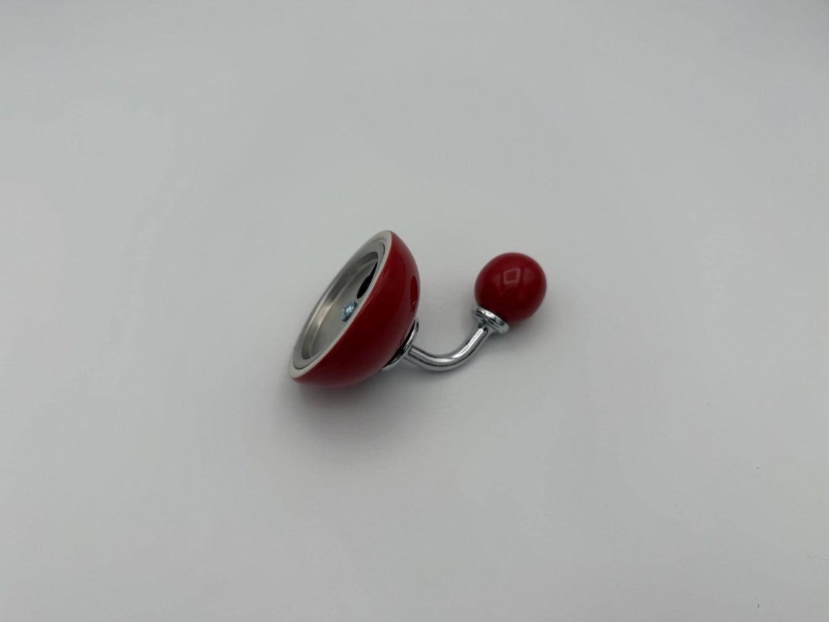 Angled rear view of a red wall hook showing its round mounting plate.