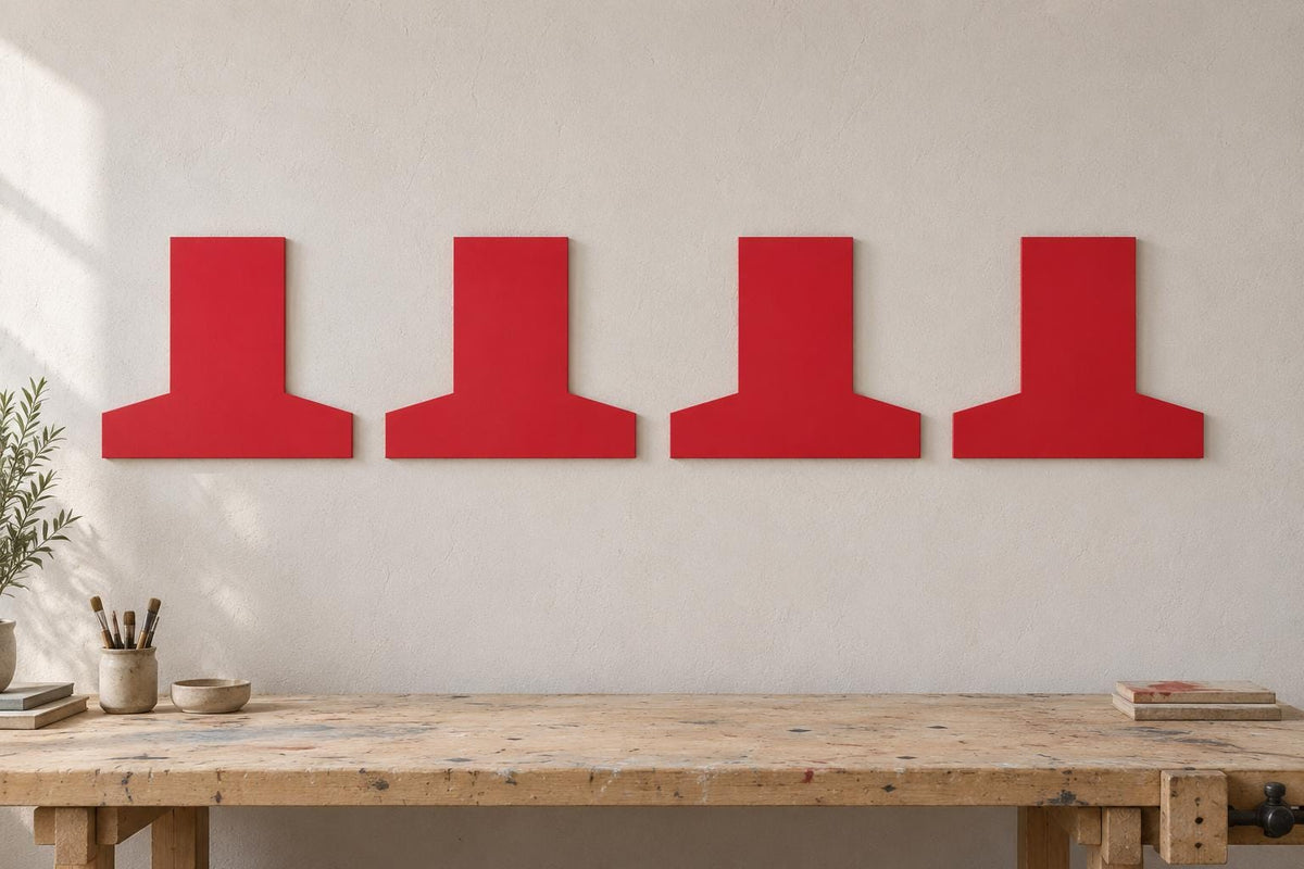 Four red inverted-T-shaped wall panels arranged above a workbench.