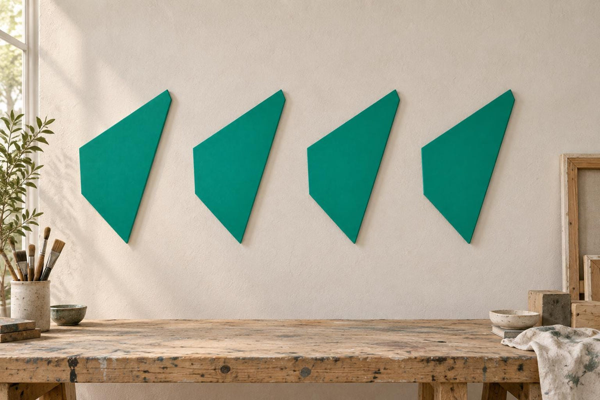 Four green angular wall panels arranged horizontally above a workbench.