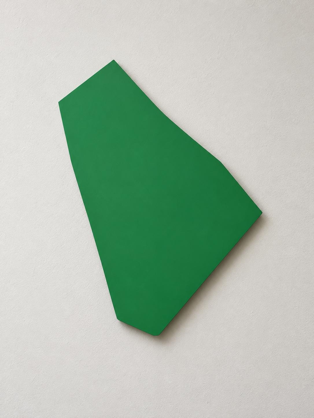 Green irregular wall panel with a sloping upper-right edge.