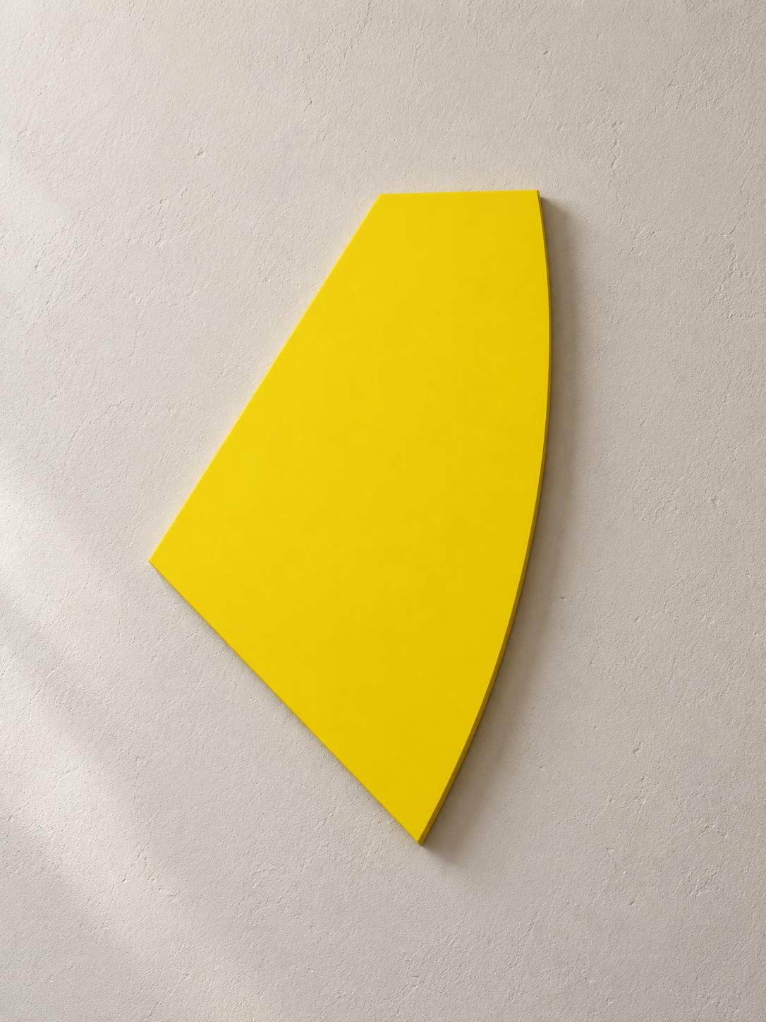 Yellow wall panel with a pointed bottom and curved right edge.