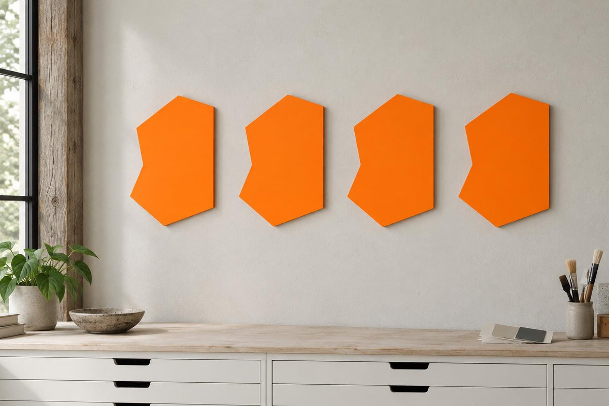 Four orange notched wall panels in a row above white cabinets.