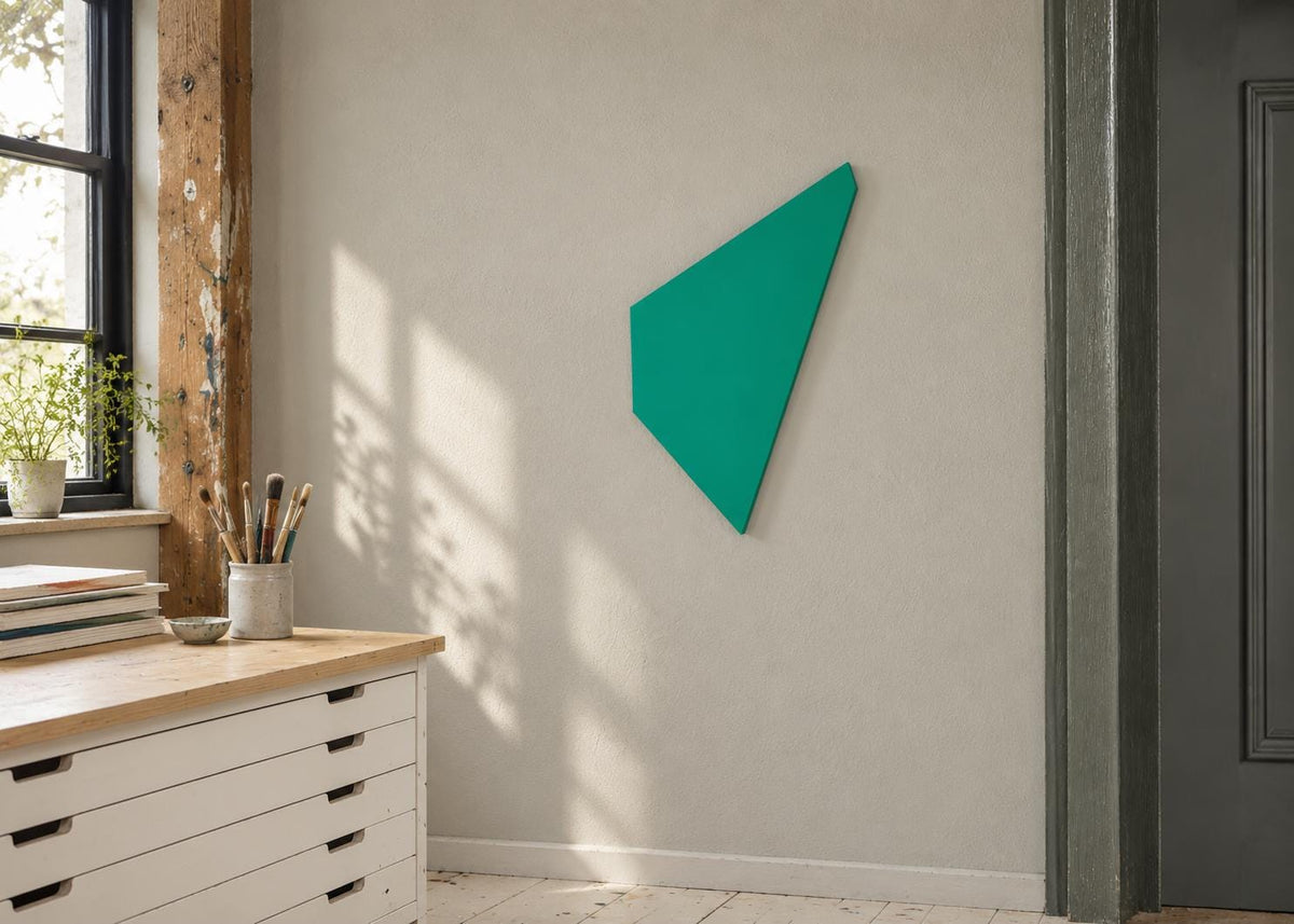 Green angular wall panel beside a sunlit studio window.