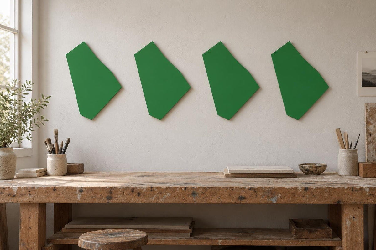 Four green irregular wall panels arranged above a workbench.
