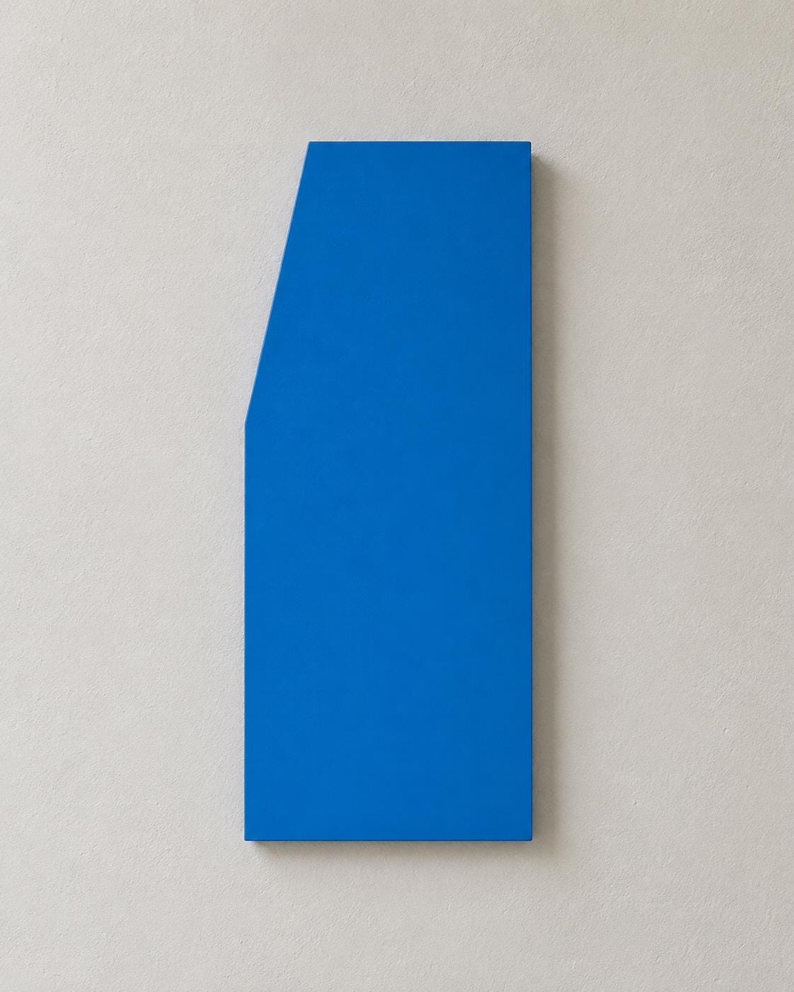 Blue wall panel with an angled upper-left edge.